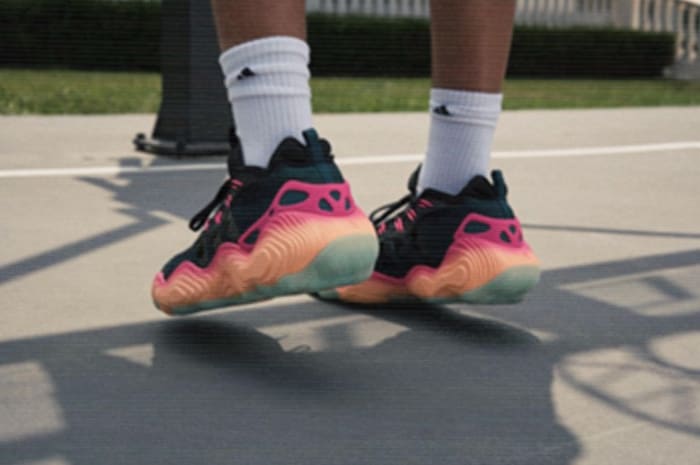 View of Trae Young's black and orange adidas basketball shoes.